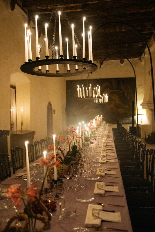 Mesa de boda con mantel morado, velas y lamparas de candelabro