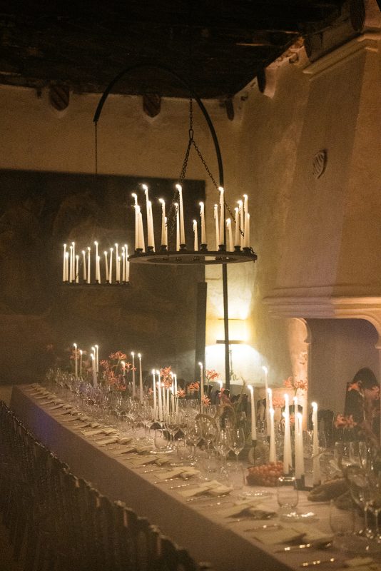Mesa de boda con mantel morado, velas y lamparas de candelabro